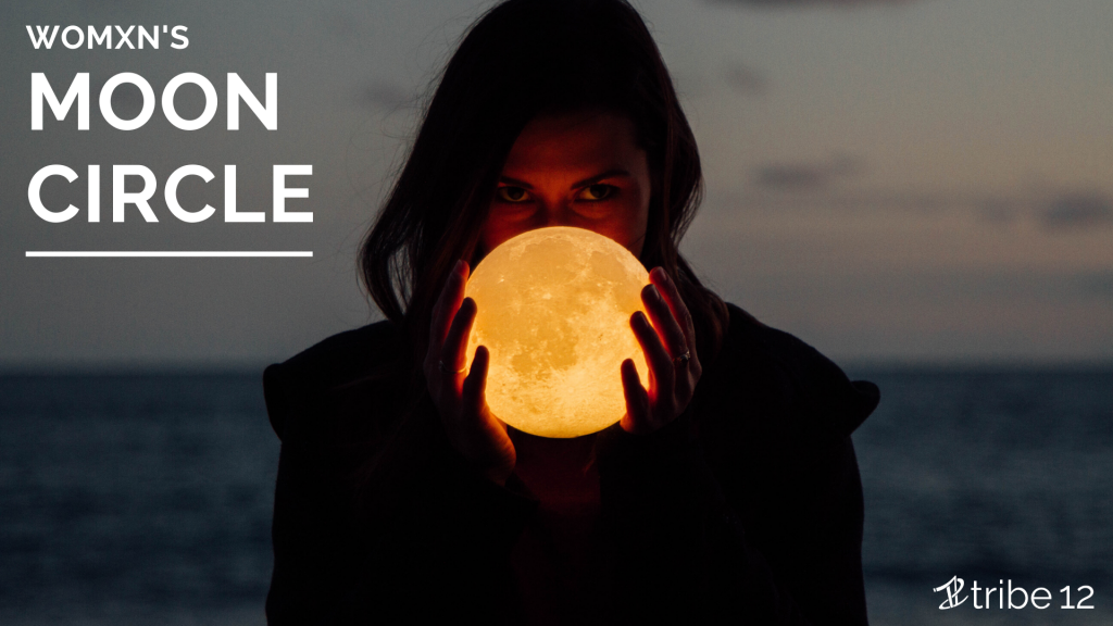 womxn's moon circle written over a photo of a woman holding a lit moon